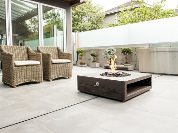 Modern patio with Lumineer fire pit and seating by Sticks and Stones